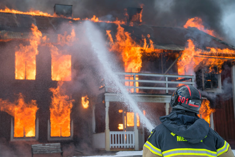 firefighter fighting a house fire