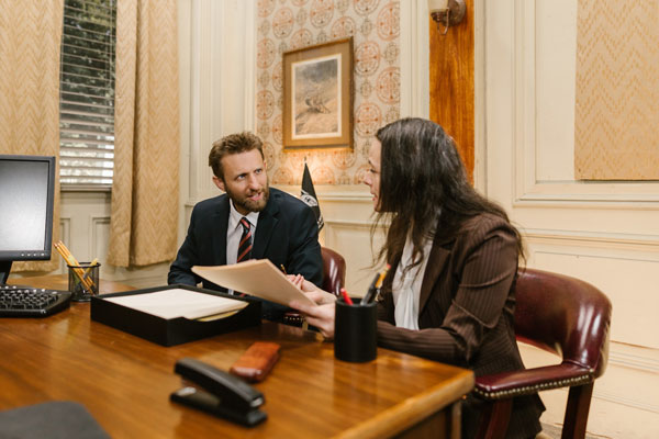 A man and a woman arguing over a paper