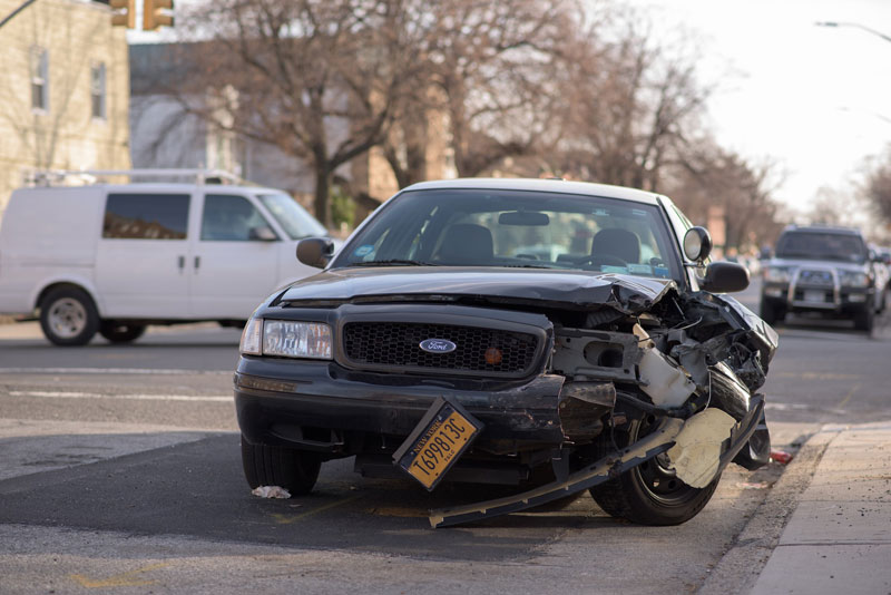 Damaged black Ford in a car crash.