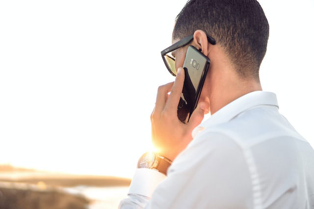 A man having a phone call outside.