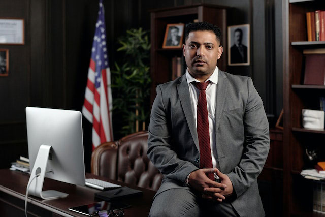 A person sitting on a desk in their office