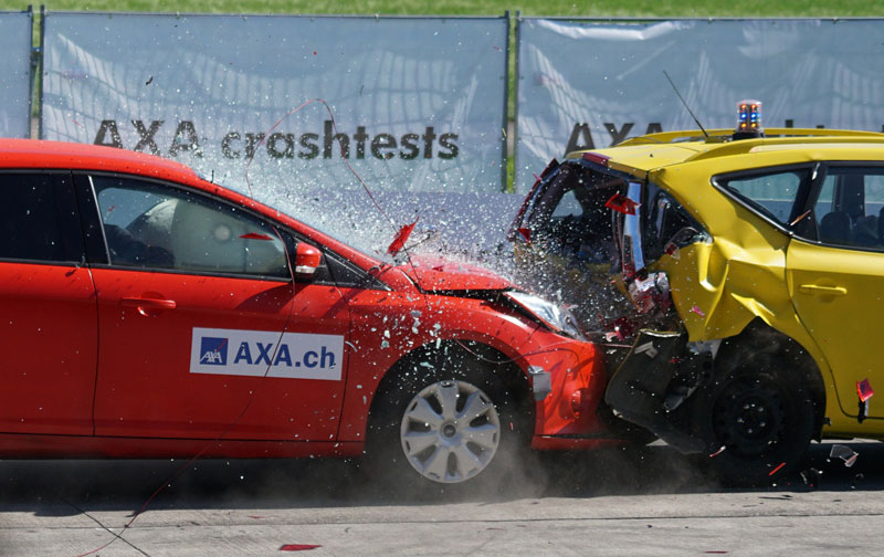 A red car hitting a yellow car from behind.